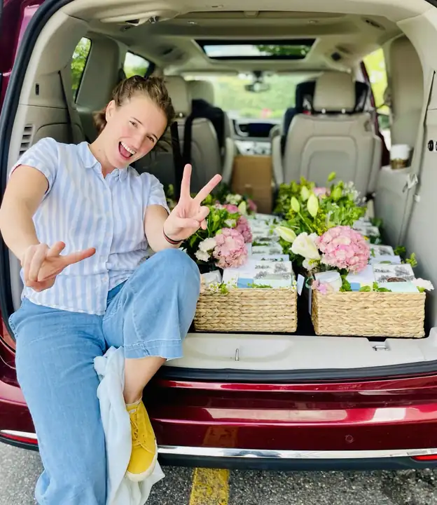 Alba with a car full of finished flower and gift baskets