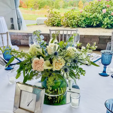 A cream and blue centrepiece on a set table