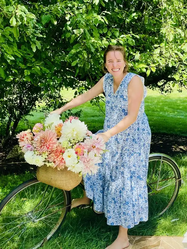 Alba on a bicycle with a basket of dahlias